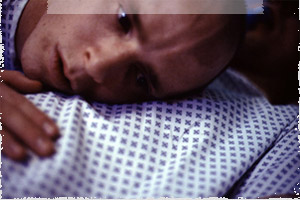 Michael (Joe McClean) listens to the beating heart of his clone.